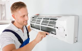 Happy Technician Repairing Air Conditioner