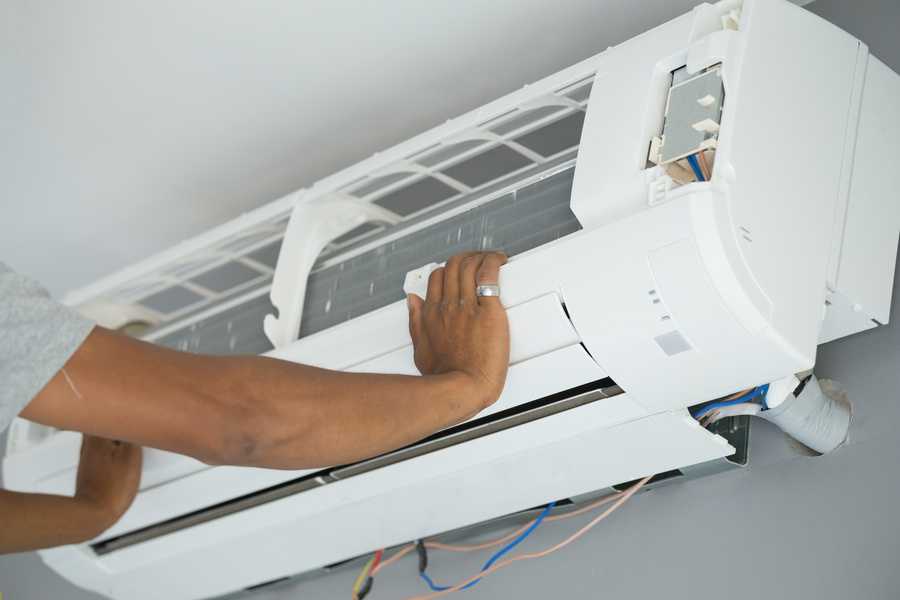Worker installing air conditioning