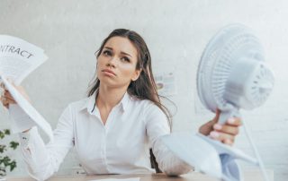 woman cooling down with fan