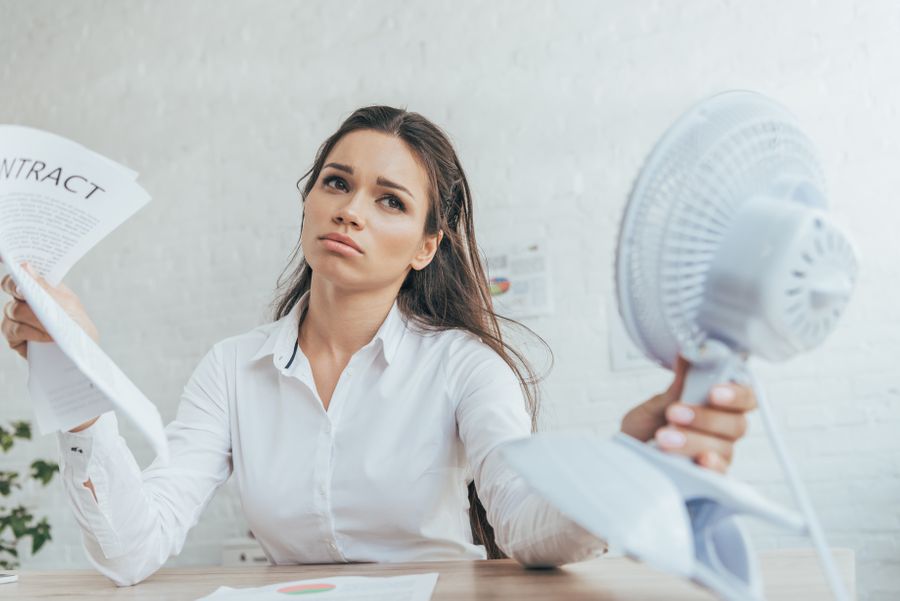woman cooling down with fan