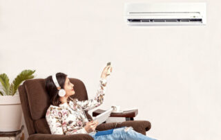 Woman using remote for heat pump control.