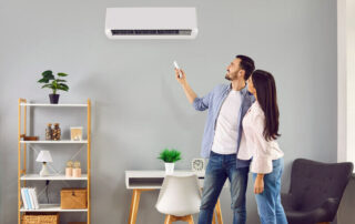 Couple turning on heat pump in living room
